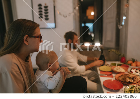 A cozy family gathering featuring a baby at the dinner table creates warm moments A cozy family gathering featuring a baby at the dinner table creates warm moments 122402866