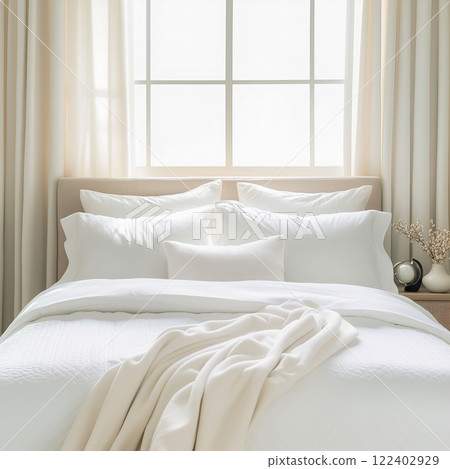 Bright white home bedroom interior, clean fresh white bed linen and pillows on bed, cozy morning room decor 122402929
