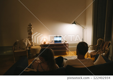 Enjoying a Cozy Night In Watching Movies and Shows Together in a Comfortable Living Room 122402934