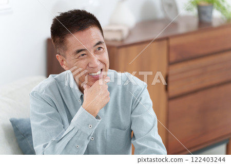 Smiling elderly man thinking Smiling elderly man thinking 122403244