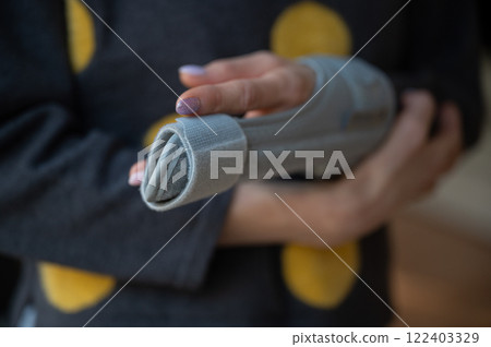 Injured finger in orthopedic brace 122403329