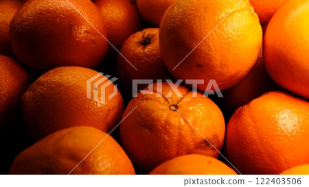 Fresh oranges beautifully lit on counter, close-up of vibrant citrus fruits with healthy nutrition concept perfect for food photography, summer fruit, organic, vitamin c rich, bright citrus freshness 122403506