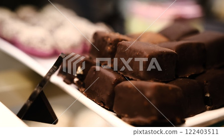 beautiful chocolate truffles on a white plate tempting handmade chocolates on display luxury confections rich chocolate treats delicious sweets gourmet indulgence mouthwatering chocolate 122403511