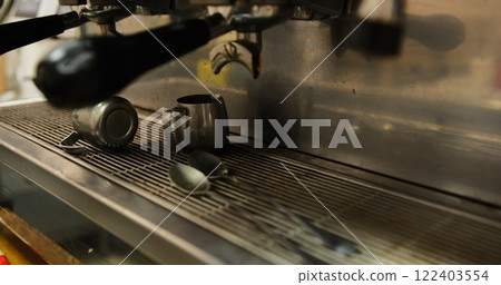 Dirty professional metal coffee machine with coffee grounds remnants close up on countertop espresso machine stains in kitchen barista workspace used for brewing coffee fresh espresso machine cleanup 122403554