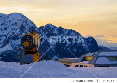 Snow cannon or gun snowing slopes or mountain for skiers and snowboarders, artificial snow 122403937