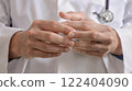 Healthcare Professionals Hands Intertwined Together in a Clinical Setting and Environment 122404090