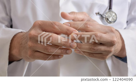 Healthcare Professionals Hands Intertwined Together in a Clinical Setting and Environment 122404090