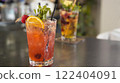 Indulge in a selection of refreshing cocktails served in stylish and vibrant glasses at a bar 122404091