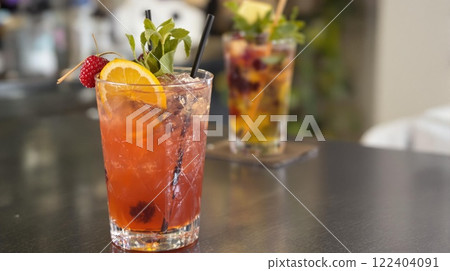 Indulge in a selection of refreshing cocktails served in stylish and vibrant glasses at a bar 122404091