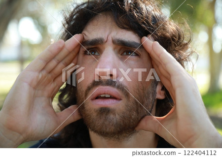 Pensive Long Hair Man Sitting On The Sidewalk Reflecting On Debts Pensive Long Hair Man Sitting On The Sidewalk Reflecting On Debts 122404112