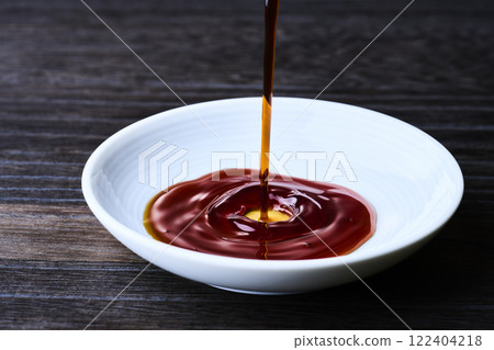 Soy sauce poured into a small dish 122404218