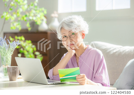 Worried senior woman, bankbook balance 122404580