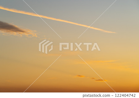 Contrails floating in the sunset sky b-1 Contrails floating in the sunset sky b-1 122404742