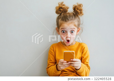 Teenage girl shows stunned expression while reading heartfelt message on her phone Teenage girl shows stunned expression while reading heartfelt message on her phone 122405528