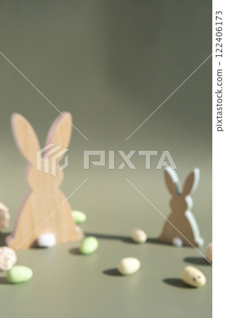 Minimalistic creative Easter concept. Two Easter bunnies under symbolic roof on green background. Celebration Easter holiday at home with family. Poster or greeting card Minimalistic creative Easter concept. Two Easter bunnies under symbolic roof on green background. Celebration Easter holiday at home with family. Poster or greeting card 122406173