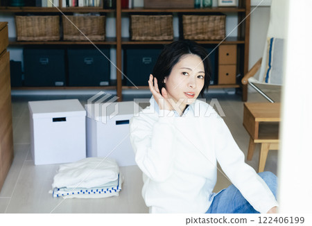 Woman looking outside from inside the room Woman looking outside from inside the room 122406199
