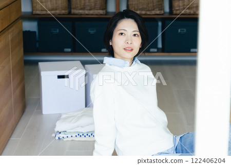 Woman looking outside from inside the room Woman looking outside from inside the room 122406204