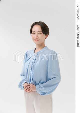 A middle-aged woman looking at the camera and smiling A middle-aged woman looking at the camera and smiling 122406238