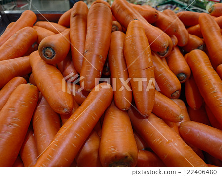 Fresh Orange Carrots Piled Up in a Market Display for Shoppers Fresh Orange Carrots Piled Up in a Market Display for Shoppers 122406480