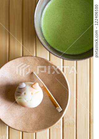 Fresh matcha drink in traditional ceramic bowl with traditional Japanese confectionery. 122406580