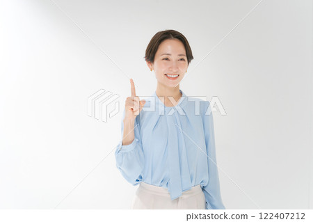 A smiling middle woman pointing 122407212