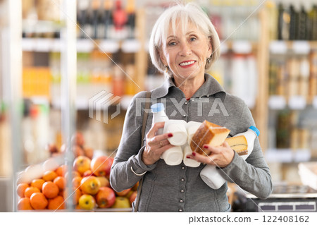 Elderly woman choosing dairy products in grocery store 122408162