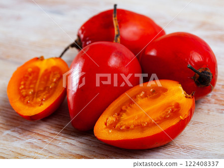 Sliced tamarillo on wooden table Sliced tamarillo on wooden table 122408337