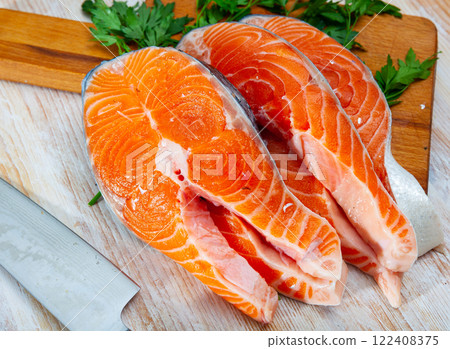 Raw salmon fillet on wooden table 122408375