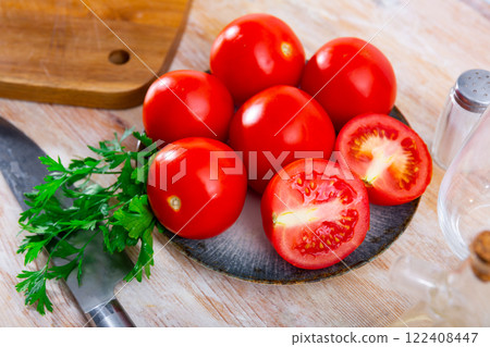 Fresh red tomatoes on wooden table 122408447