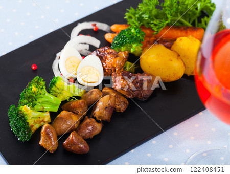 Braised chicken hearts with vegetable garnish Braised chicken hearts with vegetable garnish 122408451