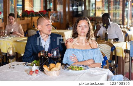 Unhappy couple quarreling during dinner at restaurant Unhappy couple quarreling during dinner at restaurant 122408595