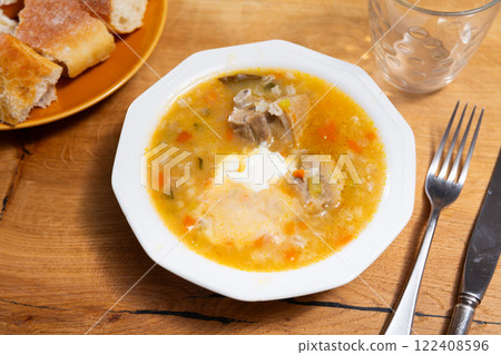 Rassolnik with sour pickles and pearl barley Rassolnik with sour pickles and pearl barley 122408596