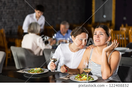Sad upset young woman shares with female friend about difficult period of relations with boyfriend 122408832