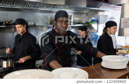 Man head chef posing in restaurant kitchen 122408908