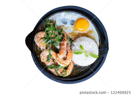 A sizzling hot plate of Thai basil shrimp stir-fry served with steamed rice and a fried egg isolate on white background with clipping path A sizzling hot plate of Thai basil shrimp stir-fry served with steamed rice and a fried egg isolate on white background with clipping path 122408925