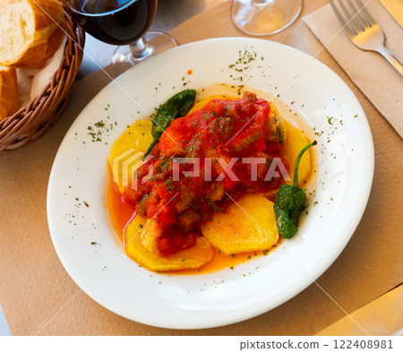 Spanish dish cod with sanfaina, sauteed vegetables and tomato sauce Spanish dish cod with sanfaina, sauteed vegetables and tomato sauce 122408981