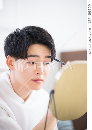 一個年輕人畫眉毛的化妝美容形象 122409409