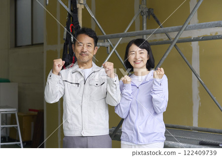 A couple of workers doing a fist pump 122409739