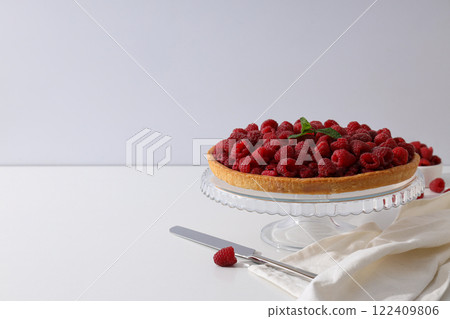 Berry pie, towel and knife on white background, space for text 122409806