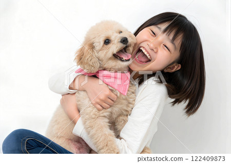Asian girl laughing with maltipoo in her arms 122409873