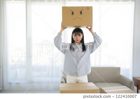 一名婦女拿著一個紙箱，上面畫著一張臉 122410007