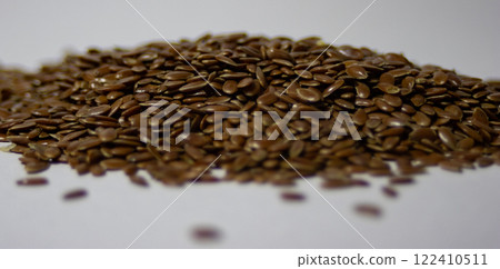 Horizontal picture of a pile of linseed with white background.Healthy food. 122410511