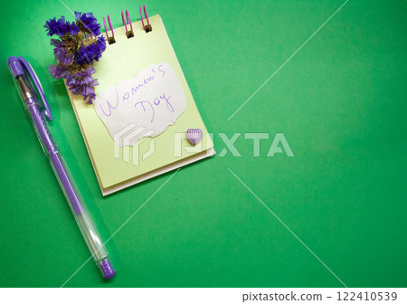 Planner with message for Women's Day . Green background . Space for copying Planner with message for Women's Day . Green background . Space for copying 122410539