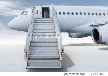 White passenger jetliner with a staircase isolated on bright background with sky 122411666