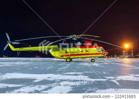 Medical helicopter on winter airport apron at night Medical helicopter on winter airport apron at night 122411683