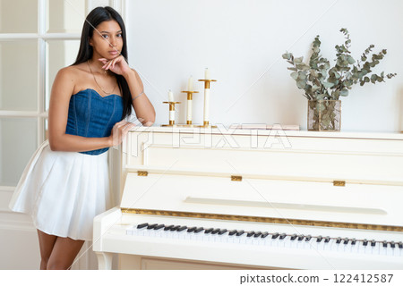 Woman student portrait with piano, musician ready for music performance. 122412587