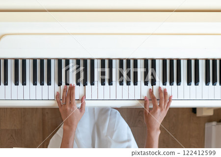 Female Practicing Piano Lessons in Home Studio 122412599
