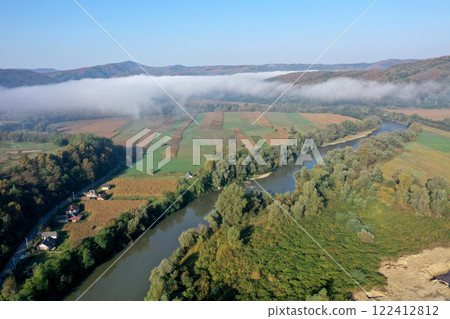 Aerial view of quiet river and forest in a misty morning Aerial view of quiet river and forest in a misty morning 122412812