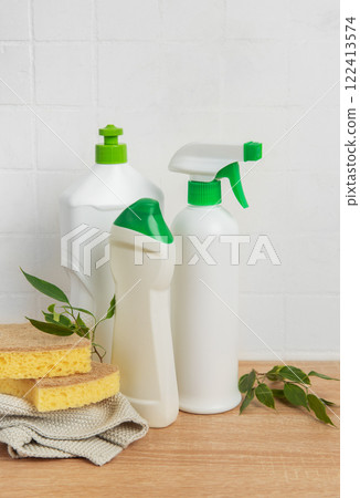 Cleaning products and sponges on wooden table promoting eco friendly cleaning 122413574