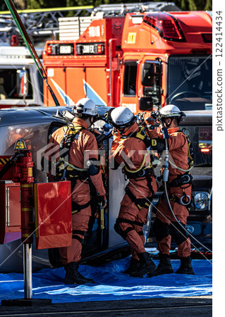 Rescue team members perform rescue training using a hydraulic cutter to cut off the roof of a car that has overturned in an accident during a fire drill at the New Year's ceremony. Rescue team members perform rescue training using a hydraulic cutter to cut off the roof of a car that has overturned in an accident during a fire drill at the New Year's ceremony. 122414434